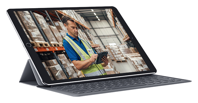Warehouse worker taking inventory on digital tablet