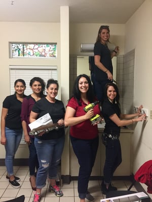 Group of women fixing up a house with power tools