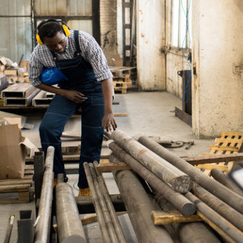 Man inspecting metal pieces