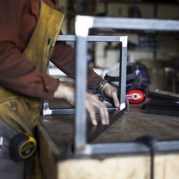 Hands laying out metal pieces