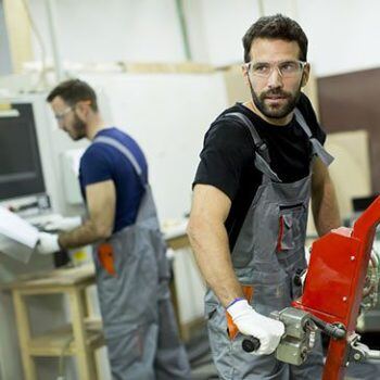 Men in overalls working in a shop