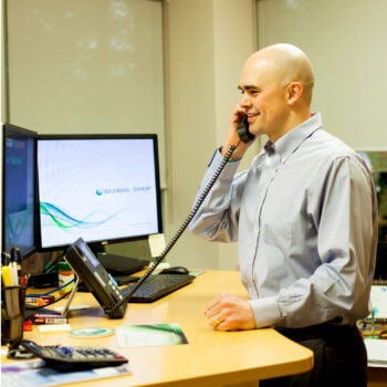 Man on phone looking at computer