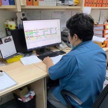 man looking at computer monitor
