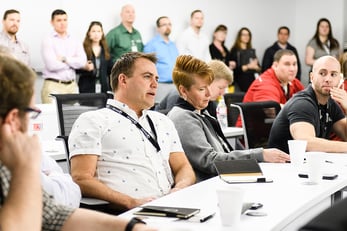 Man talking while others look on in a conference room