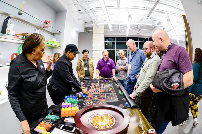 People looking at a roulette table at the Global Shop Solutions headquarters