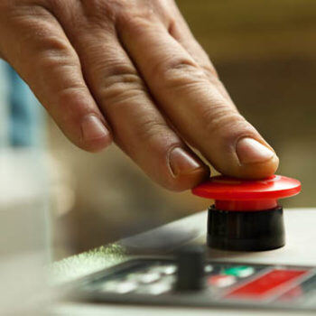 Fingers pushing a red button