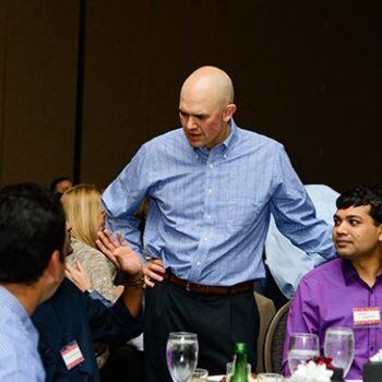 Man talking to people at a table