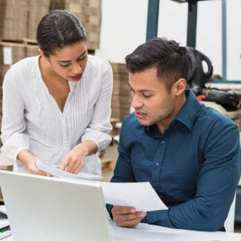 Two people discussing a paper