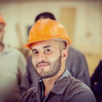 Man in hard hat smiling at camera