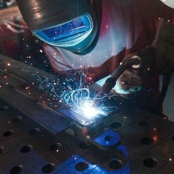 Person welding with sparks flying