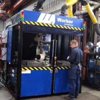 Man working on large blue machine