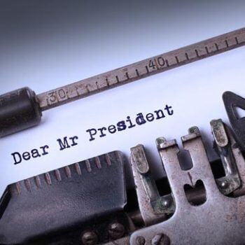Typewriter showing the words dear mr president on white paper