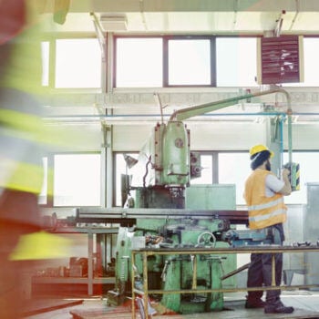 Man working on machine in manufacturing facility