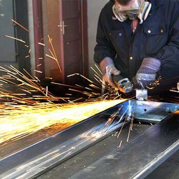 person welding with sparks flying