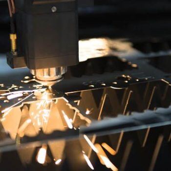Machine cutting metal with sparks flying