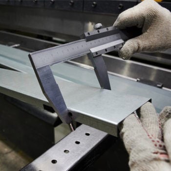 Man testing size of metal plate