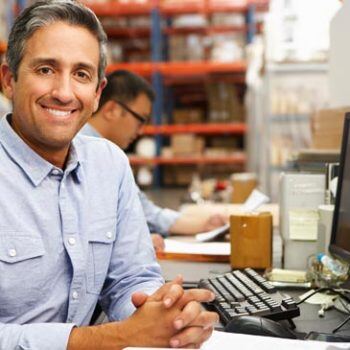 Man smiling at camera in a warehouse