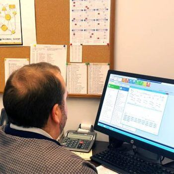 Man looking at computer with ERP software on screen