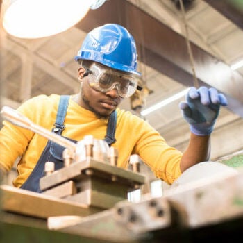 Man in hard hat working in machine shop