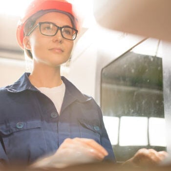 Woman in hard hat working on a computer