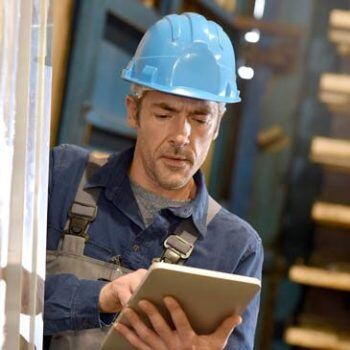 Man in hardhat working on iPad