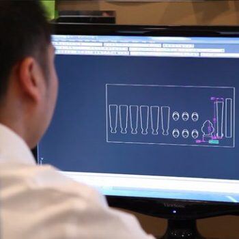 Man looking at CAD drawing on computer
