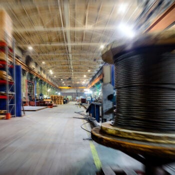 Manufacturing shop floor showcasing a spool of material