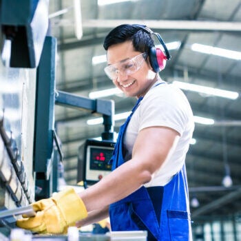 Man wearing ear protection working at machine