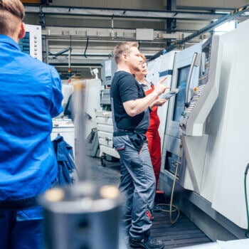 Men working on manufacturing machine