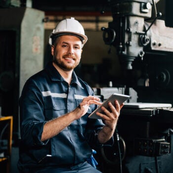 Man in a hard hat working on an iPad
