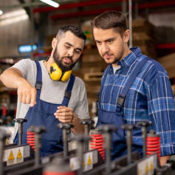 Two manufacturers looking at a machine