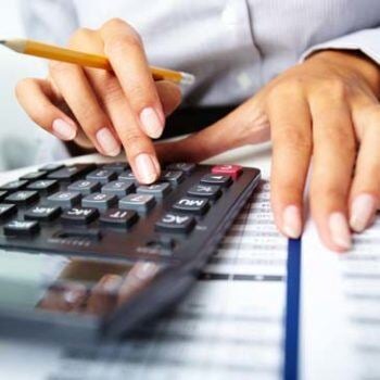 Hands working a calculator