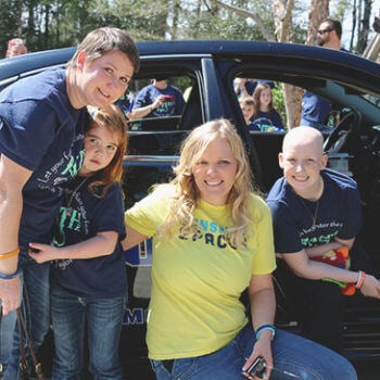 People in front of a car