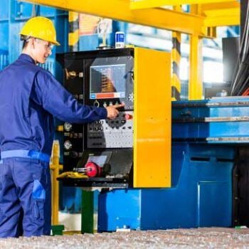 Man in hardhat working on a machine