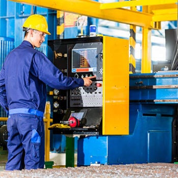 Man in hardhat working on machine