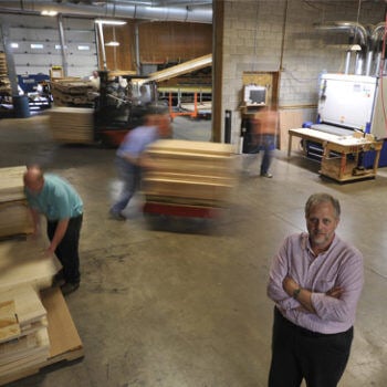 Man standing still in busy manufacturing shop floor