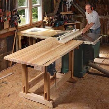 Wooden table with man standing near it