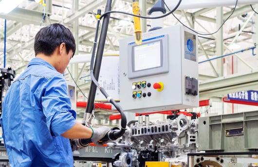 Man working at programmable CNC machine