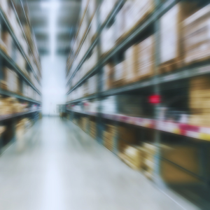 Large indoor warehouse with high racks against a blurred background