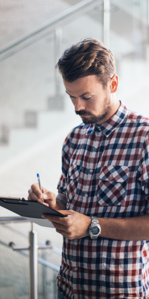 Man writing on clipboard