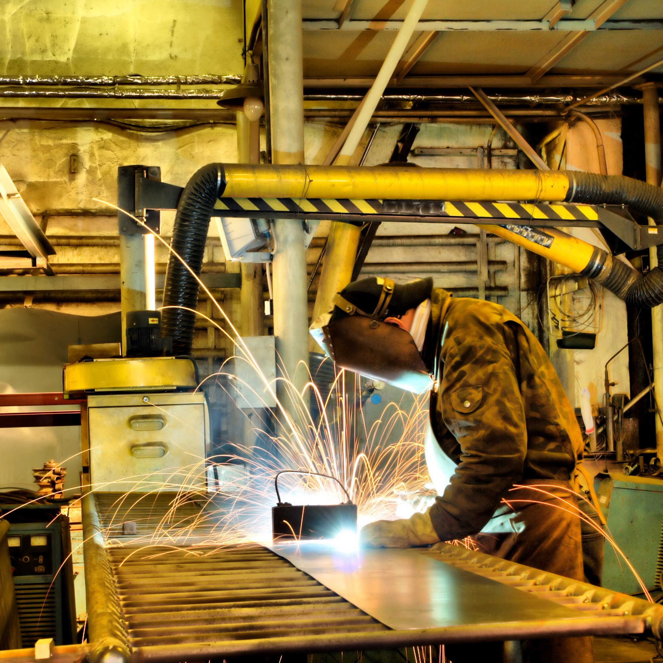 Welder working on a project in a manufacturing shop