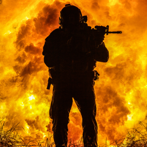 Silhouette of special forces marine operator in fire explosion background