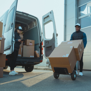 Workers loading packages into a delivery van