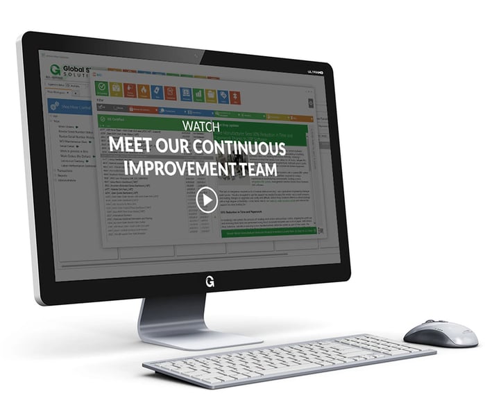 desktop and keyboard showing ERP dashboard screen with meet our continuous improvement team video title and play button overlay
