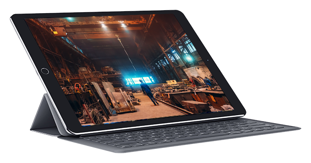 Image of man walking through factory on iPad screen Image of man walking through factory on iPad screen