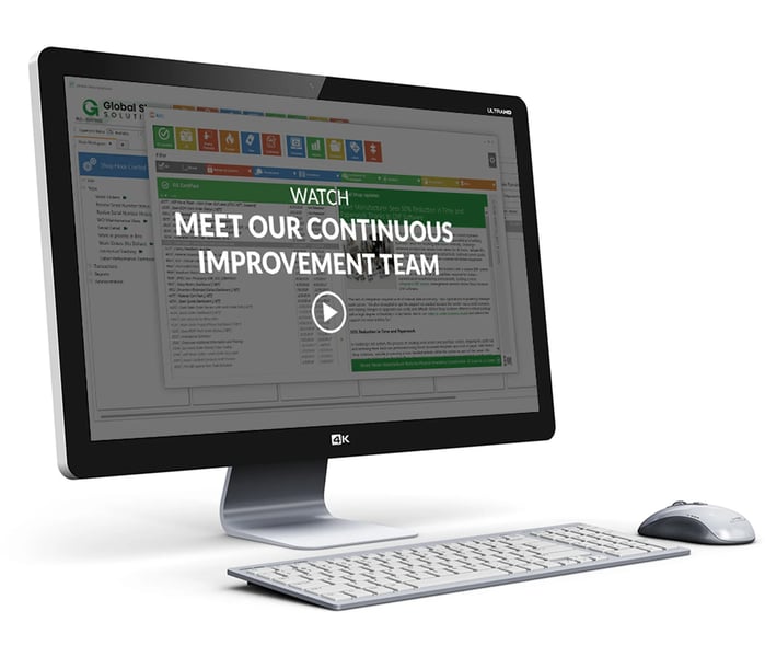desktop and keyboard showing ERP dashboard screen with meet our continuous improvement team video title and play button overlay