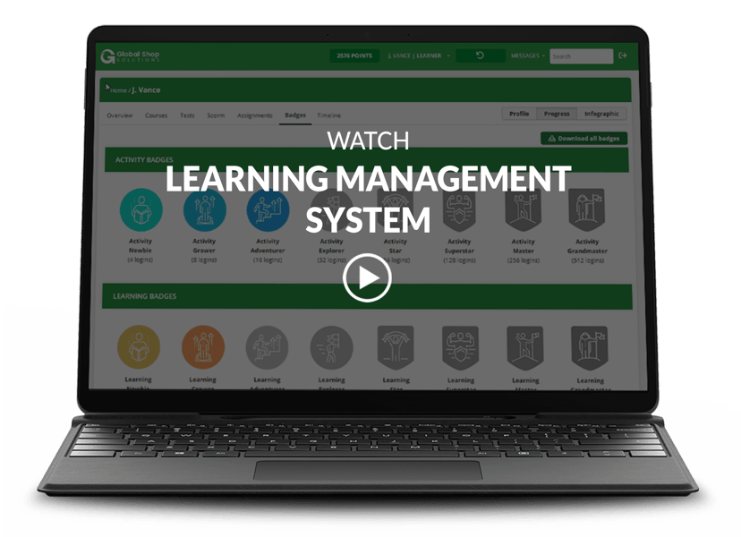 Laptop with Learning Management System screen and video title and play button on top