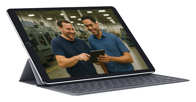 Two happy men looking at tablet on the shop floor