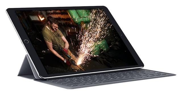 iPad with an image of a man working with a tool and sparks flying iPad with an image of a man working with a tool and sparks flying